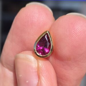 Alternative view of 18k 1.9g bezel set garnet pendant